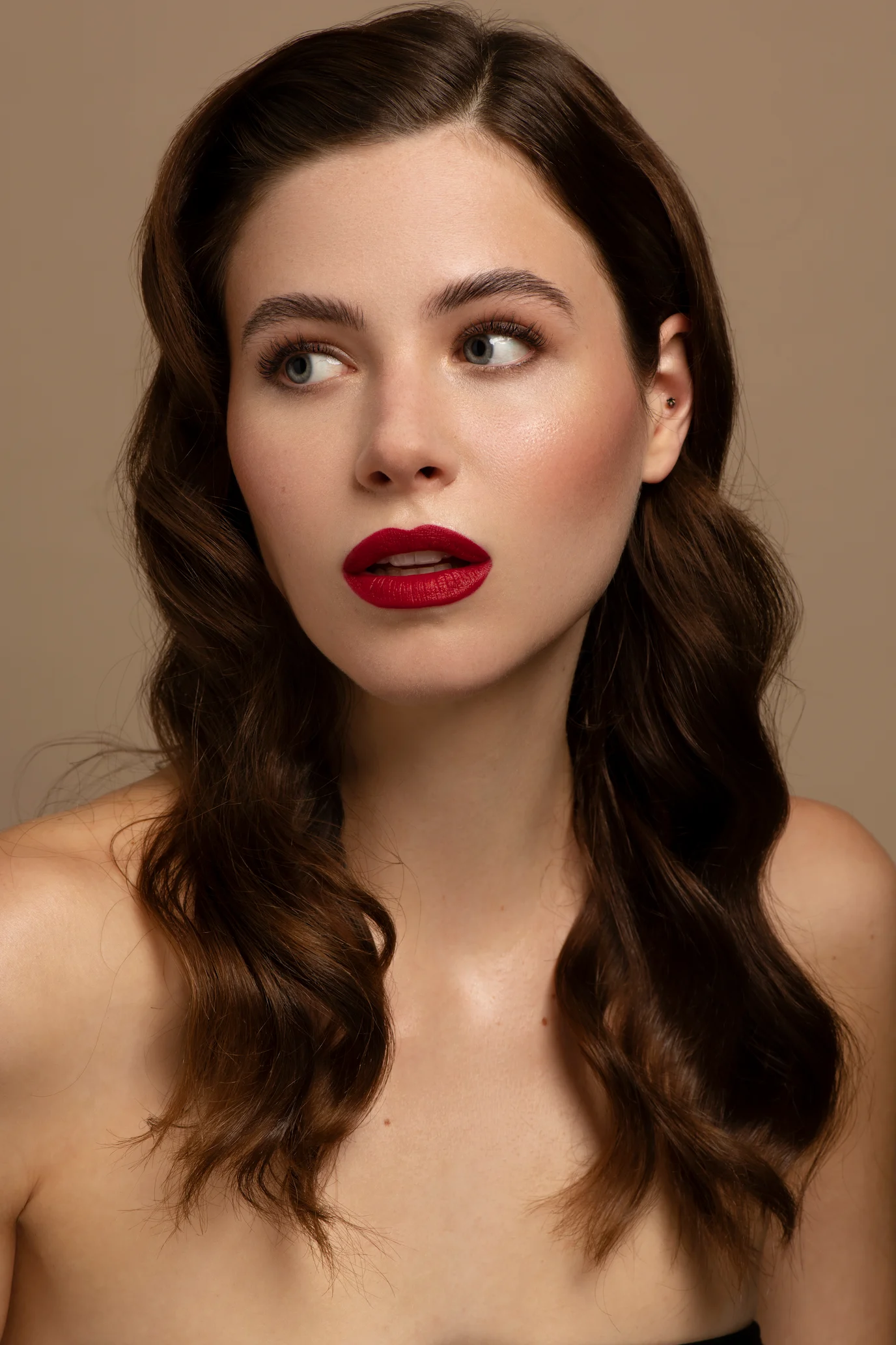 Velvety lips in an intense red, paired with radiant skin and natural eyes for a timeless, sophisticated look.